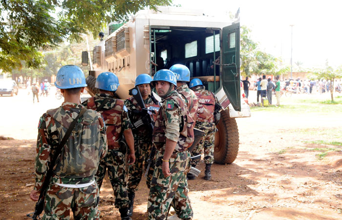 Peacekeepers from The United Nations Organization Stabilization Mission in the Democratic Republic of the Congo (MONUSCO) stand near their armored personnel carrier (APC) after a clash between the army and militia fighters in Beni, eastern Democratic Republic of the Congo. — Reuters