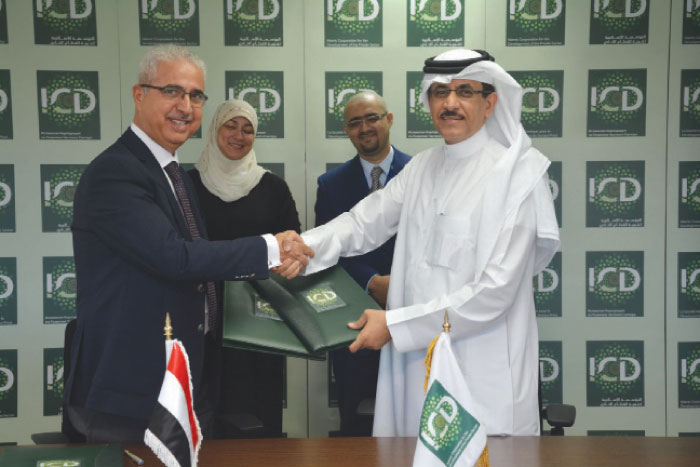 The CEO of ICD Khaled Al-Aboodi (right) and  Mahmoud Al-Refai, General Manager, TIIB, shake hands after signing the agreement at the ICD head office in Jeddah