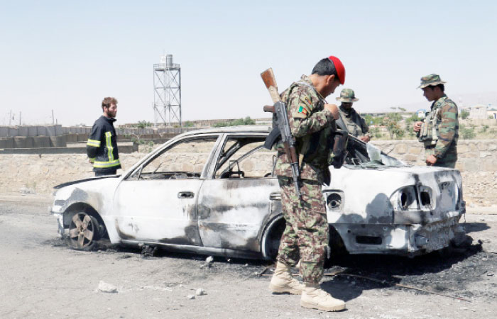 Afghan security forces inspect the exterior of a car after a suicide bomb blast in Gardez, Paktia Province, Afghanistan, on Sunday. — Reuters