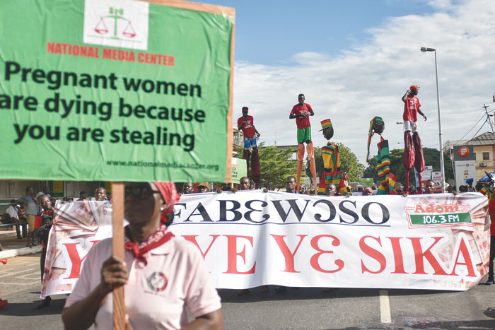 Protestors march with a banner during a demonstration dubbed ‘Fabewoso — Bring it on’ to raise awareness about the high rate of corruption in the country, in Accra.  — AFP photos