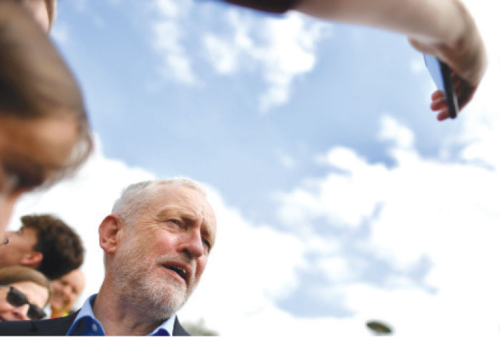 Labor party leader Jeremy Corbyn poses for a “selfie” after addressing supporters during a general election campaign rally in Reading, west of London on Wednesday as campaigning continues in the build up to the general election on June 8. Corbyn’s party has gradually nibbled away at the Conservative lead in the polls, with the campaign back in full swing after the Manchester terror attack. — AFP photos