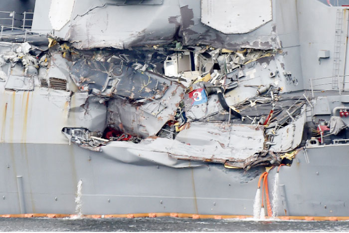 Damage to the guided missile destroyer USS Fitzgerald is seen as the vessel is berthed at its mother port in Yokosuka, southwest of Tokyo, on Sunday. — AFP