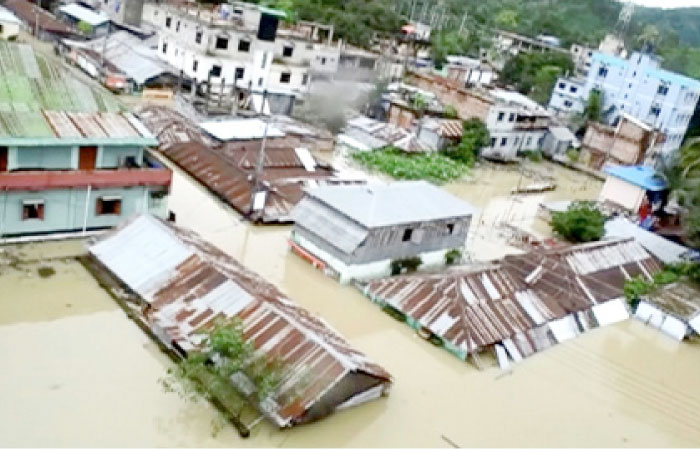 An aerial view showing the town half-submerged in floodwaters following landslides triggered by heavy rain in Khagrachari, Bangladesh, on Tuesday. — Reuters