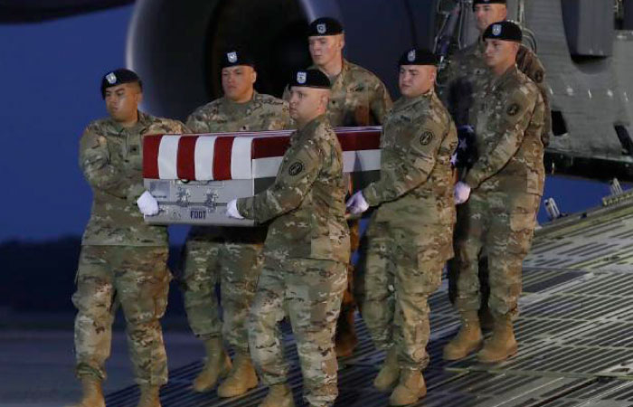 A US Army carry team moves the transfer case containing the remains of US Army Sgt. Eric M. Houck, during a dignified transfer at Dover Air Force Base, in Dover, Delaware, on Monday. — AFP