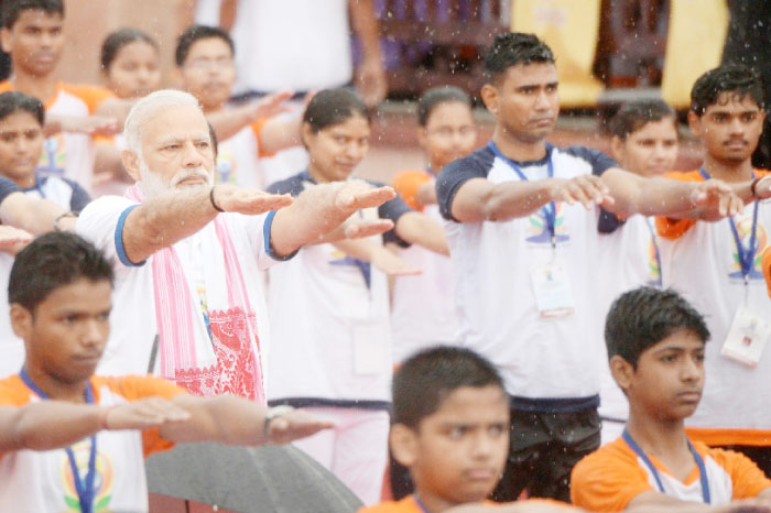 Indian Prime Minister Narendra Modi, center, participates in a mass yoga session along with other Indian yoga practitioners to mark the 3rd International Yoga Day at Ramabhai Ambedkar Sabha Sthal in Lucknow on Wednesday. — AFP