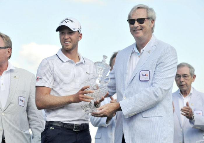 Daniel Berger (left) is awarded the FedEx St. Jude trophy after winning the FedEx St. Jude Classic golf tournament at TPC Southwind. — Reuters