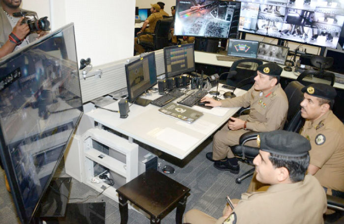 Security personnel monitor the movement of pilgrims from the Makkah Public Security headquarters in Mina through surveillance cameras installed at various places in and around the Grand Mosque. — SG photo by Badea Abu Al-Naja