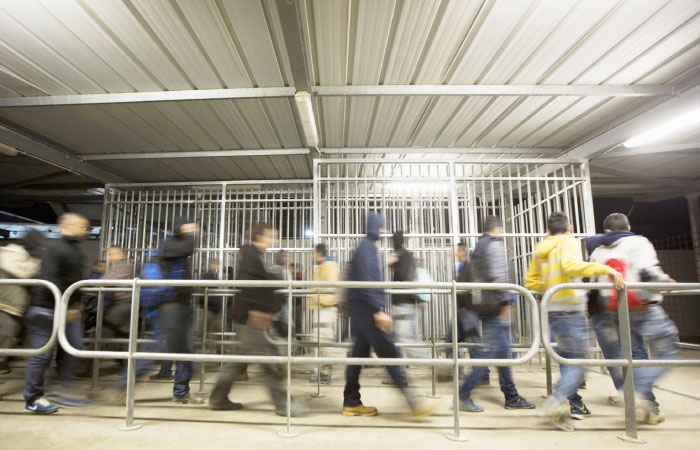 In this March 9, 2017 photo, Palestinian laborers who work in Israel cross through a checkpoint to enter Israel, near the West Bank village of Nilin. — AP photo