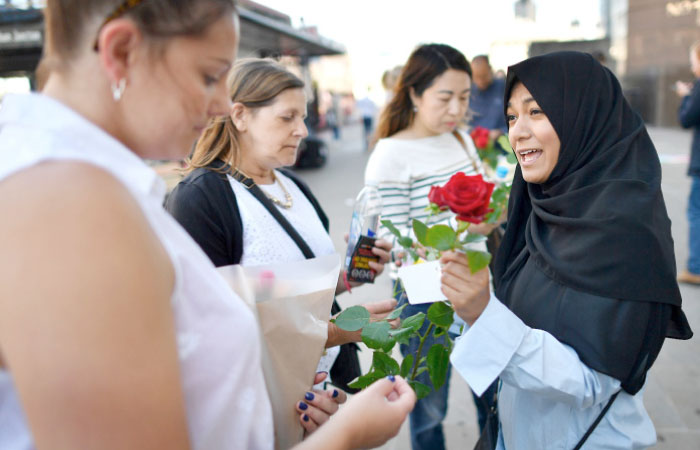 Roses are handed out to members of the public by the multi-faith group “1000RosesLondon” on London Bridge on Sunday following the June 3 terror attack that targeted members of the public on London Bridge and Borough Market. — AFP