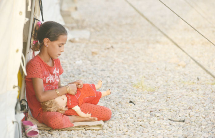 A displaced Iraqi child sits at the Hassan Sham camp for internally displaced people. — AFP