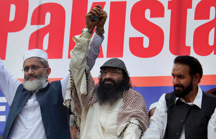 In this file photo, top leader of Hizbul Mujahideen, Syed Salahuddin, center, joins hands the leaders of Jamaat-e-Islami, Sirajul Haq, left, Mian Aslam, during an anti-India rally in Islamabad, Pakistan. — AP