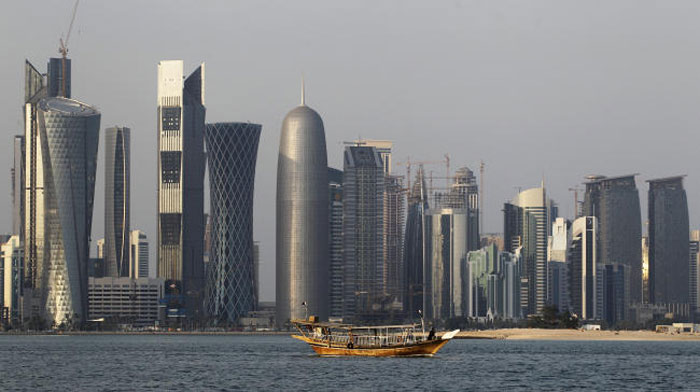 In this Thursday Jan. 6, 2011 file photo, a traditional dhow floats in the Corniche Bay of Doha, Qatar, with tall buildings of the financial district in the background. — AP