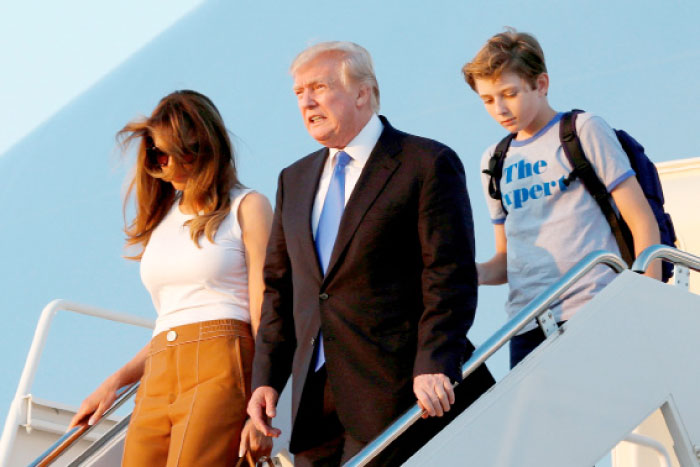 US President Donald Trump with First Lady Melania Trump and their son Barron arrive at Joint Base Andrews outside Washington, US, after a weekend at Trump National Golf Club in Bedminster, New Jersey, on Sunday. — Reuters