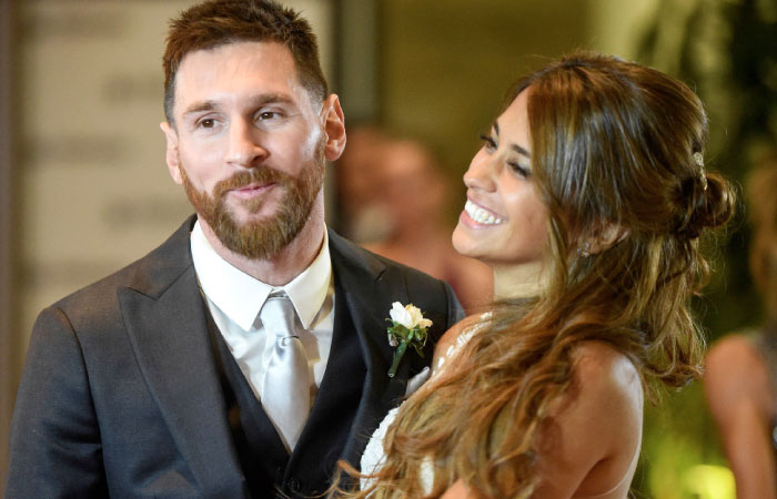 Argentine football star Lionel Messi and bride Antonella Roccuzzo pose for photographers just after their wedding at the City Centre Complex in Rosario, Santa Fe province, Argentina on Saturday. - AFP