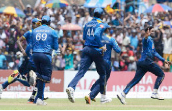 Sri Lanka's Wanidu Hasaranga (R) celebrates with his teammates after recording a hat trick during the second One-Day International cricket match against Zimbabwe at the Galle International Cricket Stadium Sunday. — AFP