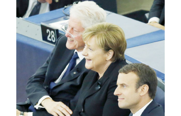 Former US President Bill Clinton, German Chancellor Angela Merkel and French President Emmanuel Macron react during of a memorial ceremony in honor of late former German Chancellor Helmut Kohl at the European Parliament in Strasbourg, France, on Saturday. — Reuters